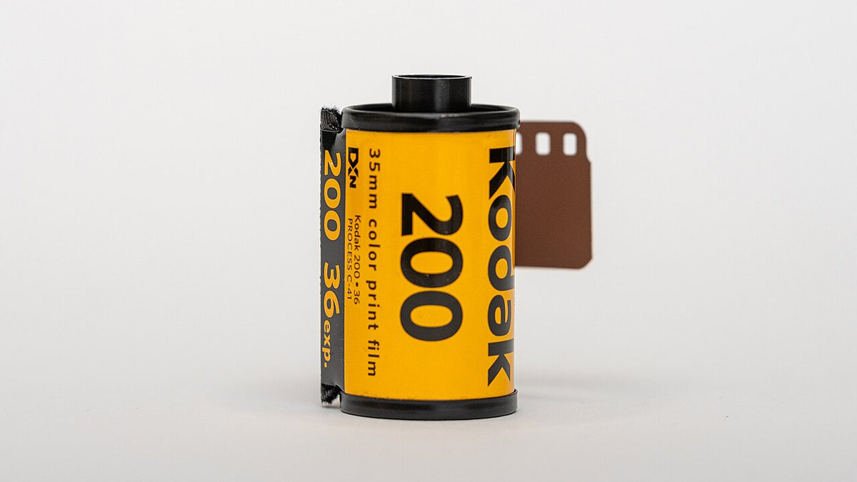 Kodak Gold 200 film roll and package beside the Gold 200 versus Portra 400 comparison