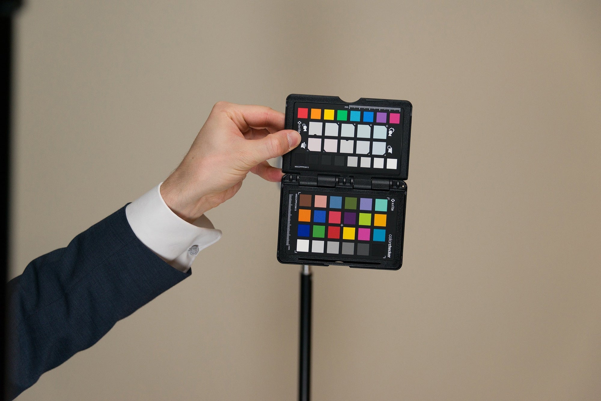 Photographer holding a ColorChecker Passport for a neutral color reference