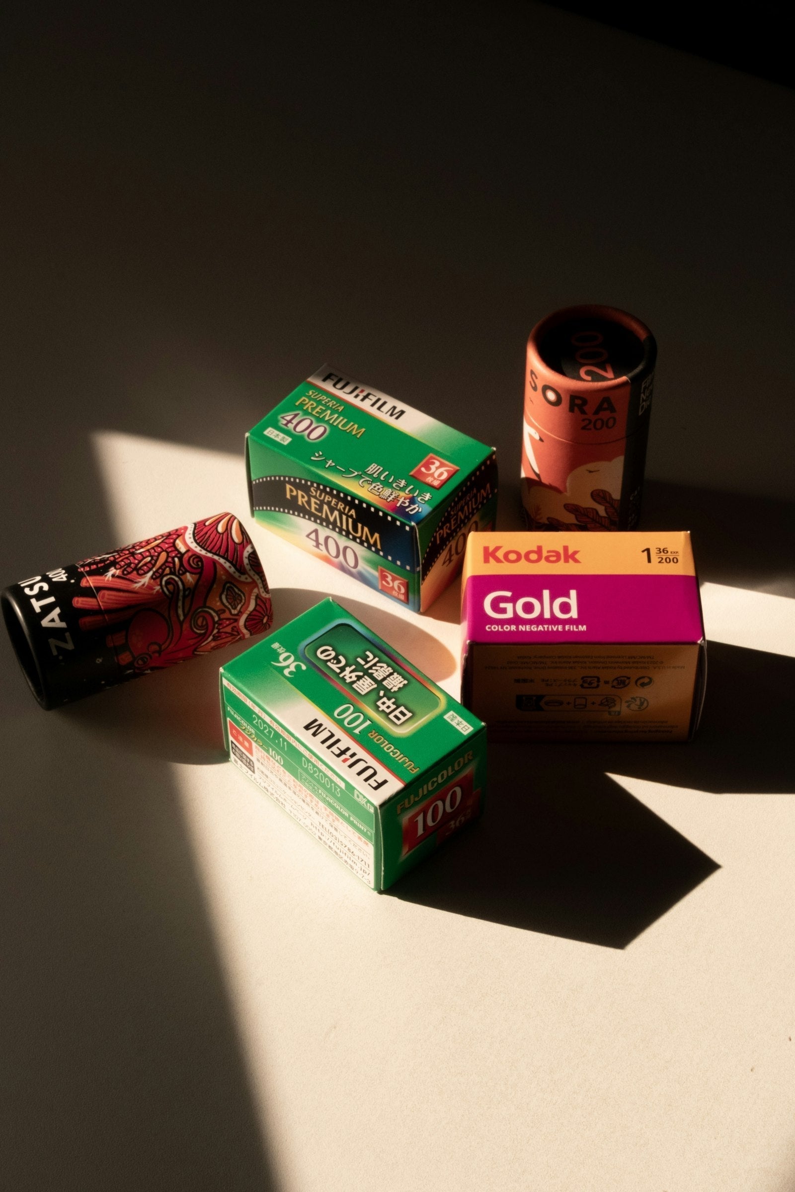 35mm film rolls arranged in warm window light